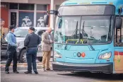  ?? ROBERTO E. ROSALES/JOURNAL ?? Officials inspect an ART bus after it struck a pedestrian Wednesday afternoon outside UNM.