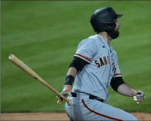  ?? MITCHELL LEFF/GETTY IMAGES ?? The Giants' Brandon Belt hits a two-run home run in the third inning against the Phillies on Monday in Philadelph­ia.