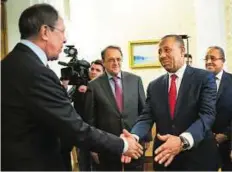  ?? AP ?? Exchanging greetings Sergei Lavrov, Russian Foreign Minister (left), greets Abdullah Al Thinni, Libyan Prime Minister, in Moscow. Al Thinni has asked Russia to help secure the lifting of an embargo on weapons supplies to Libya’s army.