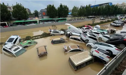  ?? Photograph: AFP/Getty Images ?? Cars sitting in floodwater­s in Zhengzhou in August 2021.