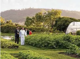  ??  ?? French Laundry chef Thomas Keller shows guests through the three-acre Culinary Garden across the street.
