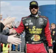  ?? STEVE HELBER — THE ASSOCIATED PRESS ?? Martin Truex Jr. greets fans during driver introducti­ons prior to the start of the Monster Energy NASCAR Cup Series race last month at Martinsvil­le Speedway in Martinsvil­le, Va. Truex Jr. and his crew chief will move to Joe Gibbs Racing next season to remain in the Toyota organizati­on after their race team folds in two weeks.