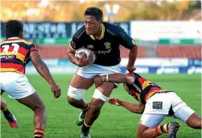  ??  ?? Lions lock Sam Lousi tests out the Waikato defence.