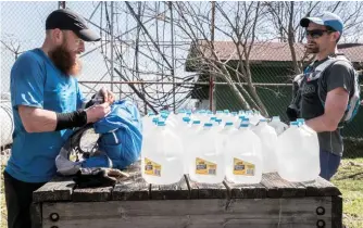  ??  ?? LEFT Gary Robbins and Jared Campbell mid-marathon filling up water in the Tennessee wilderness OPPOSITE Robbins and Barkley brother Jared Campbell heading out on a lap during the 2016 Barkley Marathons