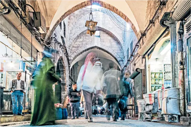  ??  ?? g Kaleidosco­pe of memories: light streams through Aleppo’s souk before the outbreak of war