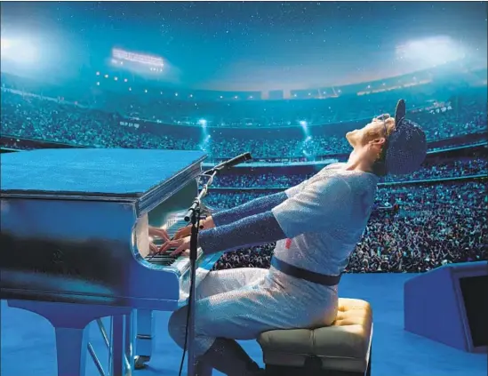  ?? David Appleby Paramount Pictures ?? TARON EGERTON as Elton John wears a sparkling Dodgers uniform, a near replica of the original, in a Dodger Stadium re-created in England in “Rocketman.”