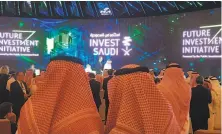  ?? Javier Blas / Bloomberg ?? An “Invest Saudi” ad is the backdrop for the Oct. 23 opening day of the Future Investment Initiative conference in Riyadh.