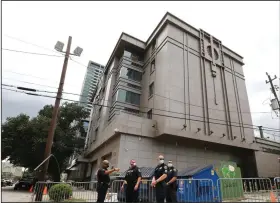  ?? (AP/Houston Chronicle/Godofredo Vasquez) ?? Police officers install barricades Friday outside the Consulate General of China in Houston. More photos are available at arkansason­line.com/725houston/