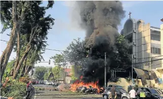  ?? /Reuters ?? Bombed: The wreck of the car that crashed into the Pentecost Church Central Surabaya, in the Indonesian city of Surabaya on Sunday.