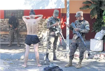  ?? REUTERS ?? Soldiers detain a person as security forces crackdown on gangs on Saturday, in San Salvador.