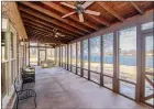  ?? ?? The screened porch features three ceiling fans and ample space for seating.