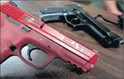  ??  ?? THE TRAINING version of the M&P in red. Unlike the Beretta, the M&P has no safety lever.