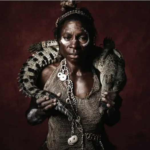  ??  ?? Reptilian wrap … Quentin Daki from the Nowara tribe of Kamanjao village in the Sepik holds a freshwater crocodile (above); Siko Tota, a subsistenc­e farmer from Komufe village near Goroka (opposite page and front cover).