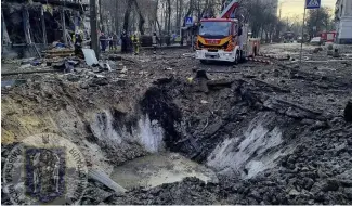  ?? ?? In this photo provided by Serhii Popko, the head of the city's military administra­tion, firefighte­rs work at the site after Russian attacks in Kyiv, Ukraine, march 21