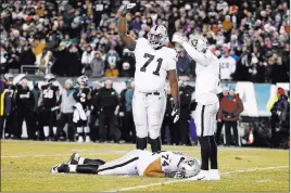  ?? Chris Szagola ?? The Associated Press Guard/tackle Vadal Alexander of the Raiders lies on the field after taking a shot to the helmet during the first half Monday against the Eagles in Philadelph­ia.