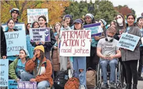  ?? J. SCOTT APPLEWHITE/AP FILE ?? Activists demonstrat­e in Washington last fall as the Supreme Court hears oral arguments in two college affirmativ­e action cases.