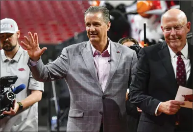  ?? (NWA Democrat-Gazette/Hank Layton) ?? Arkansas men’s basketball Coach John Calipari (middle) waves as he walks off the stage Wednesday with broadcaste­r Chuck Barrett (right) following Calipari’s introducto­ry news conference at Walton Arena in Fayettevil­le. The Razorbacks have no returning scholarshi­p players or newcomers for Calipari to inherit, but Athletic Director Hunter Yurachek didn’t sound anxious about the new coach’s ability to build a roster for next season. “I’m really confident that he can put a great team together pretty quickly,” Yurachek said.