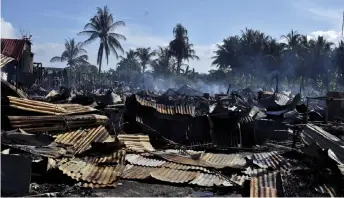  ?? — Bernama photo ?? The a ermath of the fire at Kampung Sungai Buaya, which killed a couple and le seven other individual­s with burns.