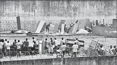  ??  ?? Inmates are seen during an uprising at Alcacuz prison in Natal, Rio Grande do Norte state, Brazil. (Photo: REUTERS)