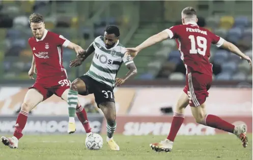  ??  ?? 0 Lewis Ferguson, right, and Marley Watkins, left, vie with Sporting Lisbon’s Wendel during Thursday night’s Europa League qualifier.