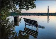  ?? AP/J. DAVID AKE ?? Water surrounds a bench Wednesday after heavy rains caused the tidal basin in Washington, D.C., to overflow.