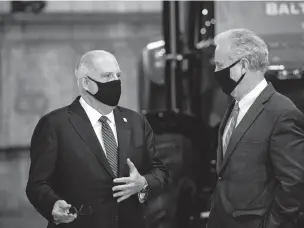  ?? AL DRAGO/NEW YORK TIMES FILE PHOTO ?? Gov. Larry Hogan of Maryland, left, speaks with Sen. Chris Van Hollen, D-Md., before President Joe Biden’s infrastruc­ture address in Baltimore in November. Senate Minority Leader Mitch McConnell has tried to recruit Hogan as a Senate candidate.