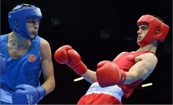  ??  ?? Adam Nolan (right) takes evasive action in his welter 69kg round of 16 contest with Andrey Zamkovoy from Russia at the London Olympics in 2012.