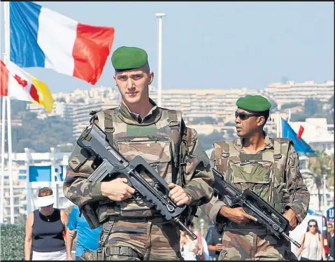  ??  ?? From top, clockwise: Soldiers patrols the Promenade des Anglais in Nice; a couple at a vigil in Seattle for the victims of the Orlando attack; people help an injured man in the Bangladesh­i capital Dhaka; and a bloodied man in Kabul, Afghanista­n