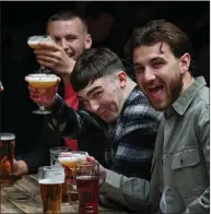  ??  ?? Friends enjoy a drink at the Three Sisters Pub in Edinburgh