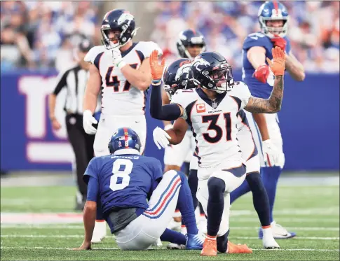  ?? Alex Trautwig / Getty Images ?? The Broncos’ Justin Simmons (31) reacts after tackling Giants quarterbac­k Daniel Jones during the fourth quarter on Sunday in East Rutherford, N.J.