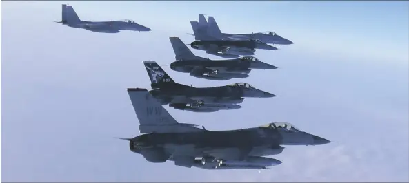  ?? JOINT STAFF OF THE JAPANESE SELF-DEFENSE FORCE VIA AP ?? This photo released by the Joint Staff of Japanese Self-Defense Force, shows two F-15 warplanes (rear left and background) of the Japanese Self-Defense Force and four F-16 fighters of the U.S. Air Force during a bilateral exercise on Sunday.