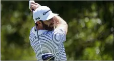  ?? DAVID J. PHILLIP — THE ASSOCIATED PRESS ?? Dustin Johnson watches his tee shot on the 14th hole during practice for the Charles Schwab Challenge in Fort Worth, Texas on Wednesday.