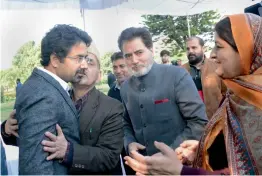  ?? — PTI ?? Newly- inducted minister Tassaduq Mufti, brother of Jammu and Kashmir chief minister Mehbooba Mufti, is greeted by his relatives after the swearing- in ceremony at Raj Bhavan in Jammu on Thursday.