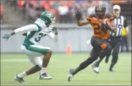  ?? The Canadian Press ?? B.C. Lions running back Jeremiah Johnson, right, carries the ball for a first down past Sam Williams of the Saskatchew­an Roughrider­s during first-half CFL pre-season action in Vancouver on Friday night. The Lions won 42-10.