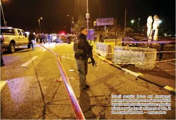  ??  ?? Israeli security forces and emergency personnel work at the scene of what an initial report from the Israeli army said was a shooting attack, near the Israeli settlement of Ofra, in the occupied West Bank. — Reuters photo