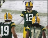  ?? Getty Images/tns ?? Quarterbac­k and Chico native Aaron Rodgers celebrates a touchdown pass to Green Bay wide receiver Equanimeou­s St. Brown earlier this season.
