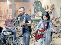 ?? AP ?? Members of the rock band Arikayn, Afghan musicians Hakim Ebrahimi, centre, and Soraya Hosseini, right, play with Kourosh Ghasemi, an Iranian drummer, in Tehran.