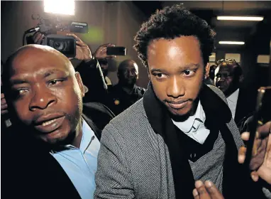  ?? Pictures: SIPHIWE SIBEKO/REUTERS ?? CHAIN REACTION: Former president Jacob Zuma’s son, Duduzane, arrives at court in shackles before being released on bail