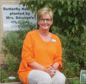  ?? MARK BUFFALO/TRILAKES EDITION ?? Cathy Dawson, a fourth-grade literacy teacher at Howard Perrin Elementary School in Benton, sits in the butterfly habitat she helped plant 10 years ago with her friend Pat Gipson. Dawson was recently named Teacher of the Year for the Benton School...