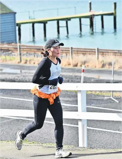  ?? PHOTO: LINDA ROBERTSON ?? Hard slog . . . Sue Kim makes her way through St Leonards during the Port Chalmers to Dunedin Road Race on Saturday. She came eighth in the women’s open grade.