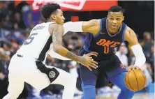  ?? Sue Ogrocki / Associated Press ?? Thunder guard Russell Westbrook, who had a triple-double, drives around Spurs guard Dejounte Murray.
