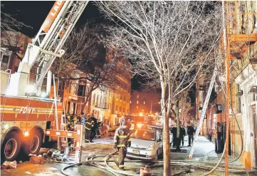  ??  ?? Fire Department of New York (FDNY) personnel work on the scene of an apartment fire in the Bronx. — Reuters photo