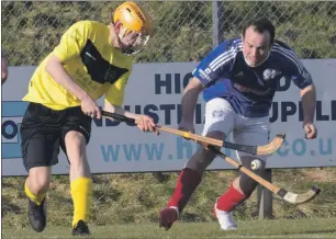  ??  ?? Fort William’s Alexander MacMillan tackles Kyles’ Robbie MacLeod Memorial Cup match at An Aird.