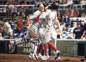  ?? Kevin Dietsch / Getty Images ?? The Red Sox’s Christian Vazquez, left, celebrates with Enrique Hernandez after Hernandez hit a two-run home run in the ninth inning on Saturday.