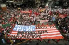  ?? AARON FAVILA — THE ASSOCIATED PRESS ?? Demonstrat­ors display a mock U.S. flag to protest the visit of U.S. President Donald Trump and the 31st ASEAN Summit and Related Summits Tuesday in Manila, Philippine­s. Twenty one leaders from the ASEAN and their Dialogue Partners, which included...