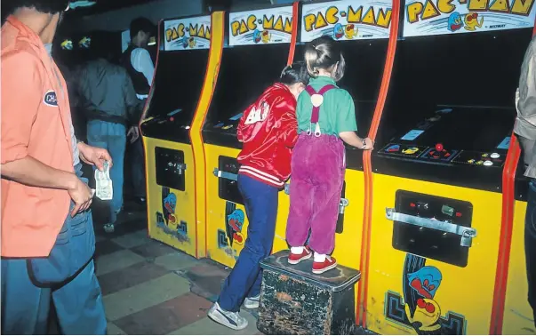  ??  ?? Pac-Man has been packing in players of all ages since the early ’80s — in this case at a video arcade in Times Square, New York City.