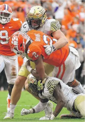  ?? | MIKE COMER/ GETTY IMAGES ?? Clemson quarterbac­k Kelly Bryant suffered a sprained left ankle while being tackled on this play in the third quarter Saturday against Wake Forest.