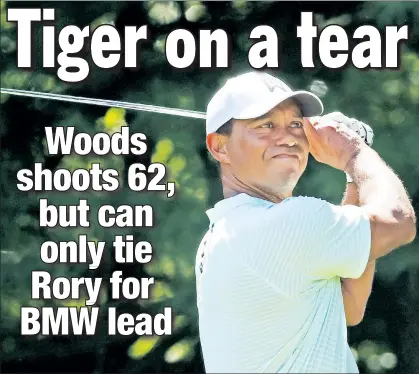  ?? Getty Images ?? HE’S IN GEAR: Tiger Woods drivesThur­sday during his dazzling 8-under 62 at the BMW Championsh­ip.