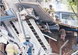  ?? BEN GRAY/AP ?? Emergency workers respond following an apartment explosion Sunday in Dunwoody, Georgia, just outside of Atlanta. The collapse left the complex unstable.