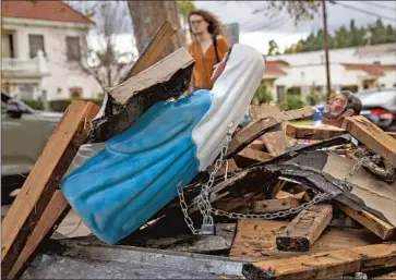  ?? A PEDESTRIAN Photograph­s by Mel Melcon Los Angeles Times ?? walks past a Nativity scene from which a baby Jesus figure was stolen outside Founders Metropolit­an Community Church in Los Feliz. The display reminded passersby about wars around the globe.